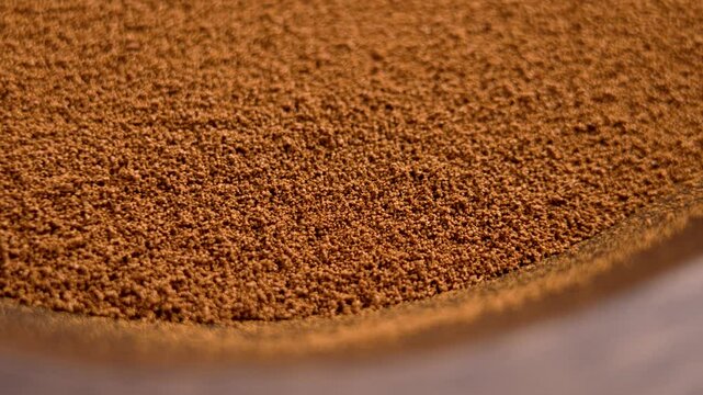 Granular instant chicory in a wooden bowl. Healthy nutritional drink ingredient. Macro shot. Top view. Rotation