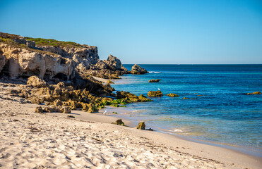 Rocky Coastline and Sandy Beach with Clear Ocean Under Blue Sky at Burns Beach, Perth, Australia,...