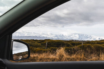 Snowy Sierra de Gredos Mountains Viewed from Car Window on Overcast Winter Day in Spanish Countryside