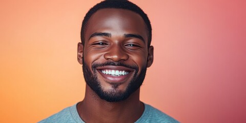 A man with a big smile on his face is wearing a gray shirt
