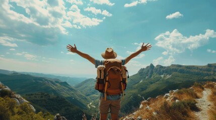 A person with a backpack is standing on a mountain and is looking up at the sky