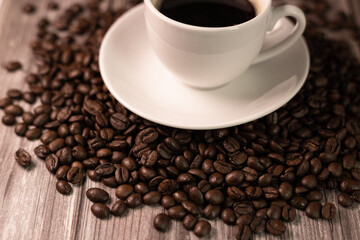 A cup of espresso coffee. A cup of coffee stands on coffee beans.