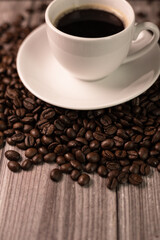 Aromatic coffee in a white cup. Esresso cup on a wooden table