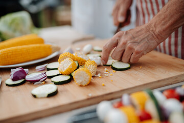 Close up of family preparing food for a spring weekend barbecue.