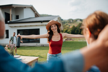 Parents welcoming their daughter at a family barbecue.