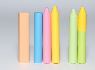 Six colorful crayons arranged in a row, featuring varied shapes and shades from peach to green