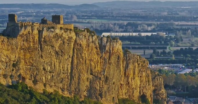 Mornas Fortress stands majestically on top of a rocky cliff. The Fortress of Mornas is a medieval fortress above the village of the same name in the French department of Vaucluse