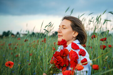 Woman stands gracefully with Beautiful Poppies Smiling Happily in Sunlit Field. Serene moment of woman among blooming flowers, enjoying peace and tranquility in natures embrace. Banner with copy space