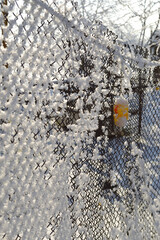 Snow covered the metal mesh