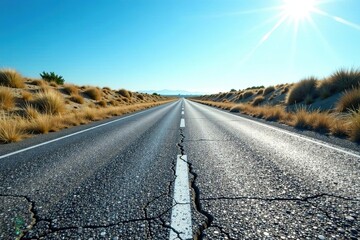 Cracked and weathered asphalt road under a clear blue sky,  transportation,  outdoor