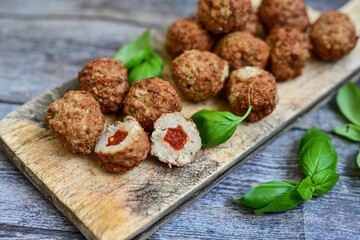 Mini  home made pork  oven baked meatballs with salsa filling.
 Party fingerfood. Diet  ketogenic food.