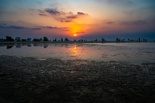 Sunset at Colva Goa beach in South India, silhouette of boats and people,  tropical west coast, Arabian Sea in Asia, vacation destination