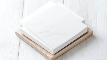 Fototapeta premium White Books Wooden Coasters Minimalist Style High-Resolution Subtle Lighting Top-Down View Clean Lines Mockup Display on White Wood Background Bright Neutral Tones Perfect for Branding Projects
