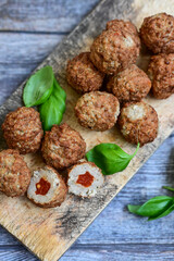 Mini  home made pork  oven baked meatballs with salsa filling.
 Party fingerfood. Diet  ketogenic food.