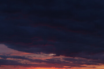 Background of purple evening clouds with pink stripes at the bottom