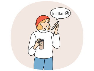 Woman is recording voice messages holding phone and plastic glass of coffee in hands. Beautiful girl uses voice messages to communicate with friends via internet or post on social networks