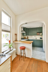 A bright and airy modern kitchen featuring an open layout, wooden flooring, and sleek cabinets. The space is enhanced by natural light and greenery.