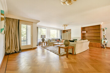 A bright and spacious living room featuring comfortable furniture, decorative elements, and large...