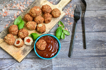 Mini  home made pork  oven baked meatballs with salsa filling.
 Party fingerfood. Diet  ketogenic food.
