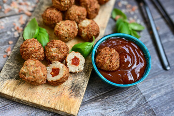 Mini  home made pork  oven baked meatballs with salsa filling.
 Party fingerfood. Diet  ketogenic food.