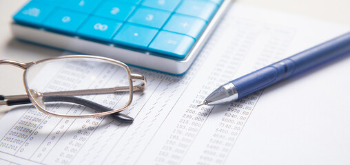 Financial accounting with a calculator and pen. Finance