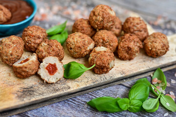 Mini  home made pork  oven baked meatballs with salsa filling.
 Party fingerfood. Diet  ketogenic food.