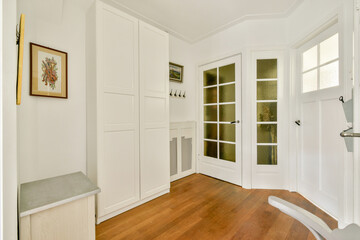 A bright and inviting interior showcasing minimalist design with wooden flooring and contemporary furnishings, ideal for functional living.