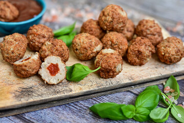 Mini  home made pork  oven baked meatballs with salsa filling.
 Party fingerfood. Diet  ketogenic food.