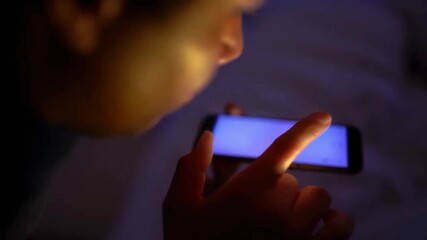 Person enabling blue light filter on smartphone, nighttime screen use, digital eye strain prevention, sleep-friendly mobile screen, warm tone display at night, technology and health awareness