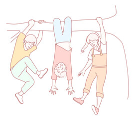 A group of fun and carefree kids is joyfully enjoying outdoor playtime while hanging upside down from trees