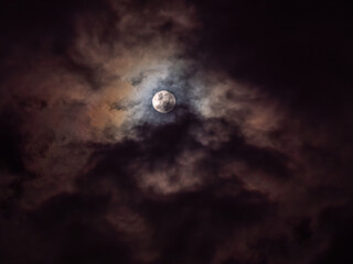 Ethereal Moon Veiled by Crimson-Violet Clouds