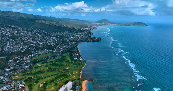 Footage above the coastline of Honolulu, Hawaii. Panorama of densely built city at the shore of the Pacific Ocean.