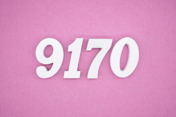 The numbers are made of white painted wood and placed on a pink paper background.
