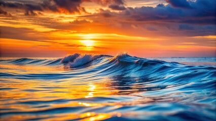 Obraz premium Beautiful ocean waves reflecting an orange glow of the evening sky with a serene and peaceful atmosphere, ocean, blue, ocean