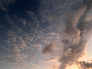 Beautiful sky with natural gradations. Thick clouds in the dusk sky on a winter night. Image of a cloudy sky in the afternoon. View of the night sky with golden light from the evening sun