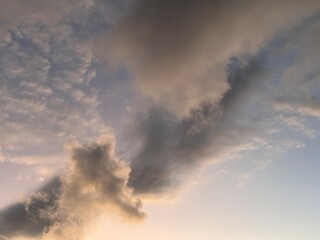 Beautiful sky with natural gradations. Thick clouds in the dusk sky on a winter night. Image of a cloudy sky in the afternoon. View of the night sky with golden light from the evening sun