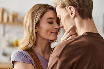 Young couple sharing a tender moment at home, embracing love and connection in modern style
