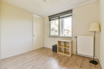 This image showcases a minimalist interior design featuring light-colored walls, wooden flooring, and simple furniture elements.