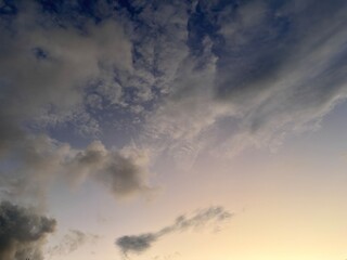 Beautiful sky with natural gradations. Thick clouds in the dusk sky on a winter night. Image of a cloudy sky in the afternoon. View of the night sky with golden light from the evening sun