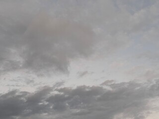 Obraz premium Beautiful sky with natural gradations. Thick clouds in the dusk sky on a winter night. Image of a cloudy sky in the afternoon. View of the night sky with golden light from the evening sun