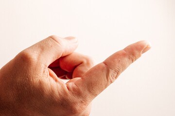 Person showing a wooden splinter stuck in the fingertip, ideal for injury or medical themes.