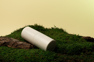Minimalist cosmetic bottle mockup on moss with natural wood background.  Eco-friendly minimalistic...