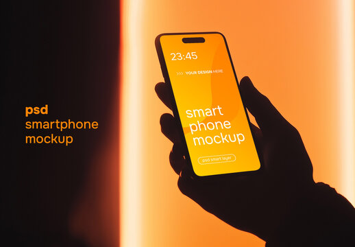Hand holding a smartphone on orange background