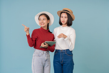 Two cheerful women using a digital tablet and stylus pen together. Friendly communication, creative...