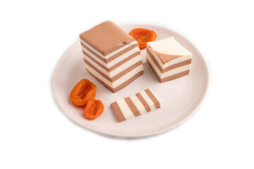 Cocoa and milk jelly with dried apricots isolated on white background, side view