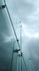 Obraz premium Close-up of glass panels and metal fixings, showing modern architectural detail, suggesting strength, transparency, and contemporary design