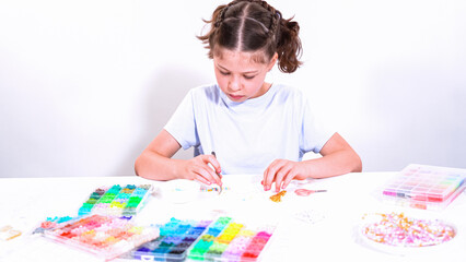 Little GirlAdventure in Bracelet Making with a Rainbow of Beads