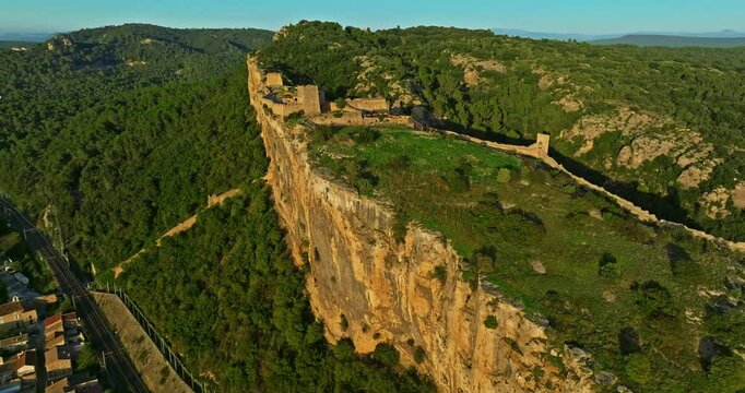Mornas Fortress stands majestically on top of a rocky cliff. The Fortress of Mornas is a medieval fortress above the village of the same name in the French department of Vaucluse