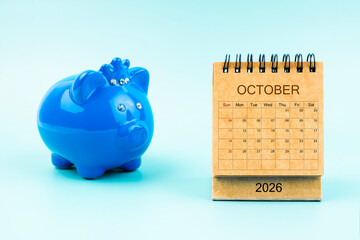 Blue piggy bank and blank October 2026 calendar, Reminder schedule of savings money.