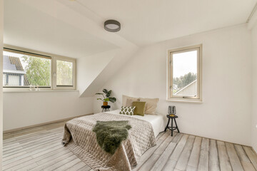 A bright and airy bedroom featuring minimalist furniture, natural light, and a cozy atmosphere, ideal for relaxation and tranquility.